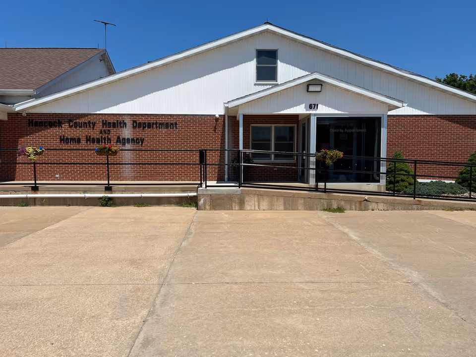 Exterior view of Hancock County Health Department building with ramped entrance.