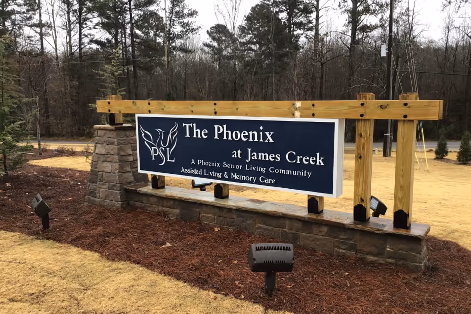 Exterior sign reads The Phoenix at James Creek in front of facility.