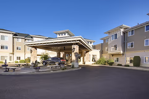 Exterior view of Fairwinds Spokane with a covered entrance and parked cars.
