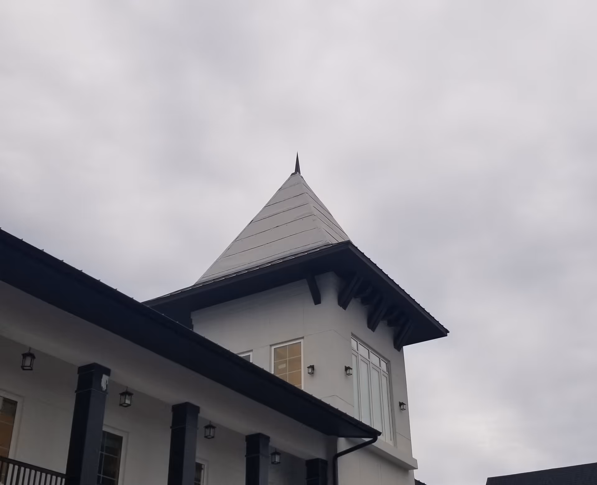Exterior view of The Blake at Miramar Beach with a pointed-roof tower.