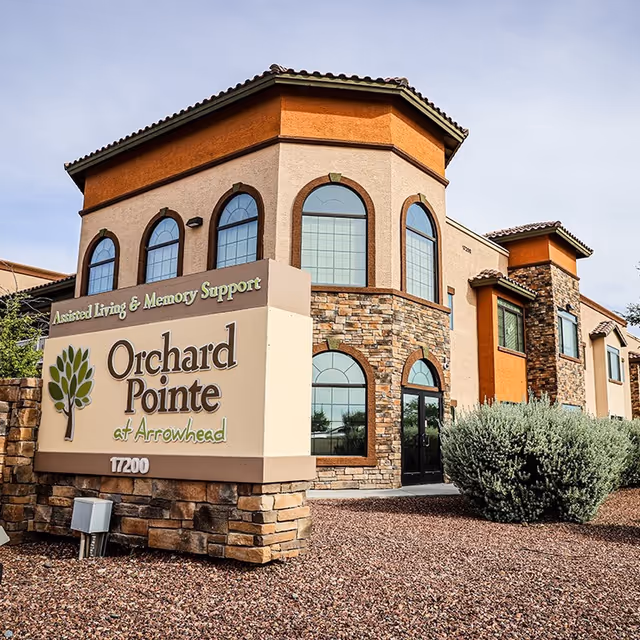 Exterior view of Orchard Pointe at Arrowhead senior living building with stone facade.