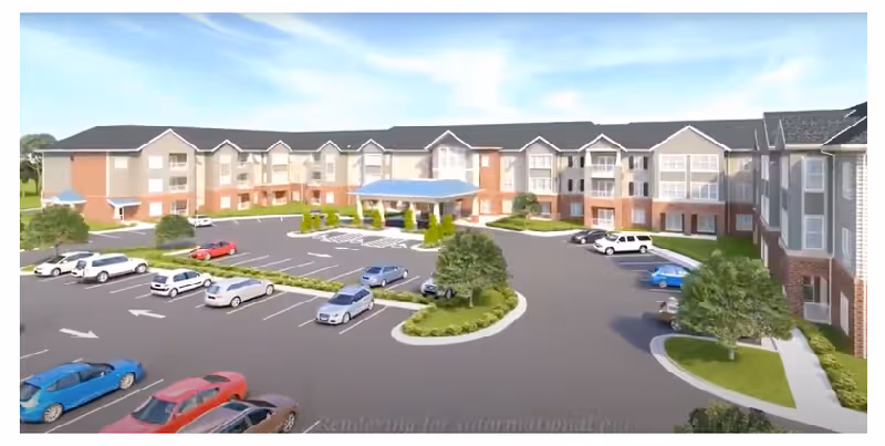 Exterior view of The Crossings at Eastchase building with parking and landscaped drive.