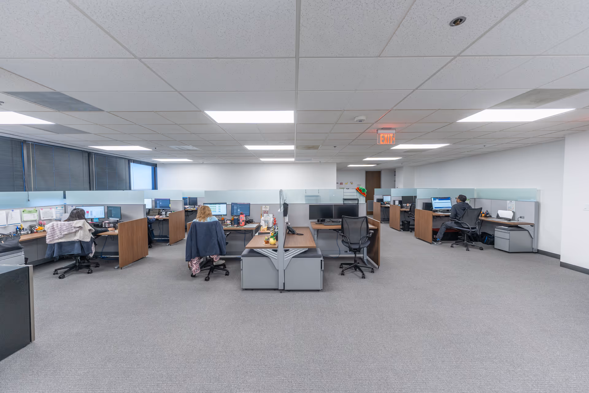 Lucent Health Group administration office with cubicles, desks, and staff working at computers.