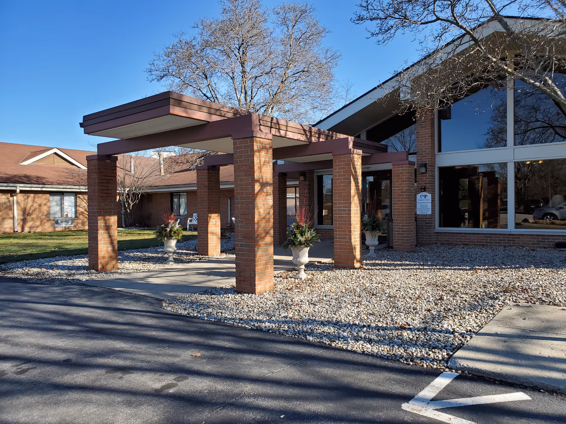 Brick entrance canopy with columns greets visitors at Majestic Care of Avon.