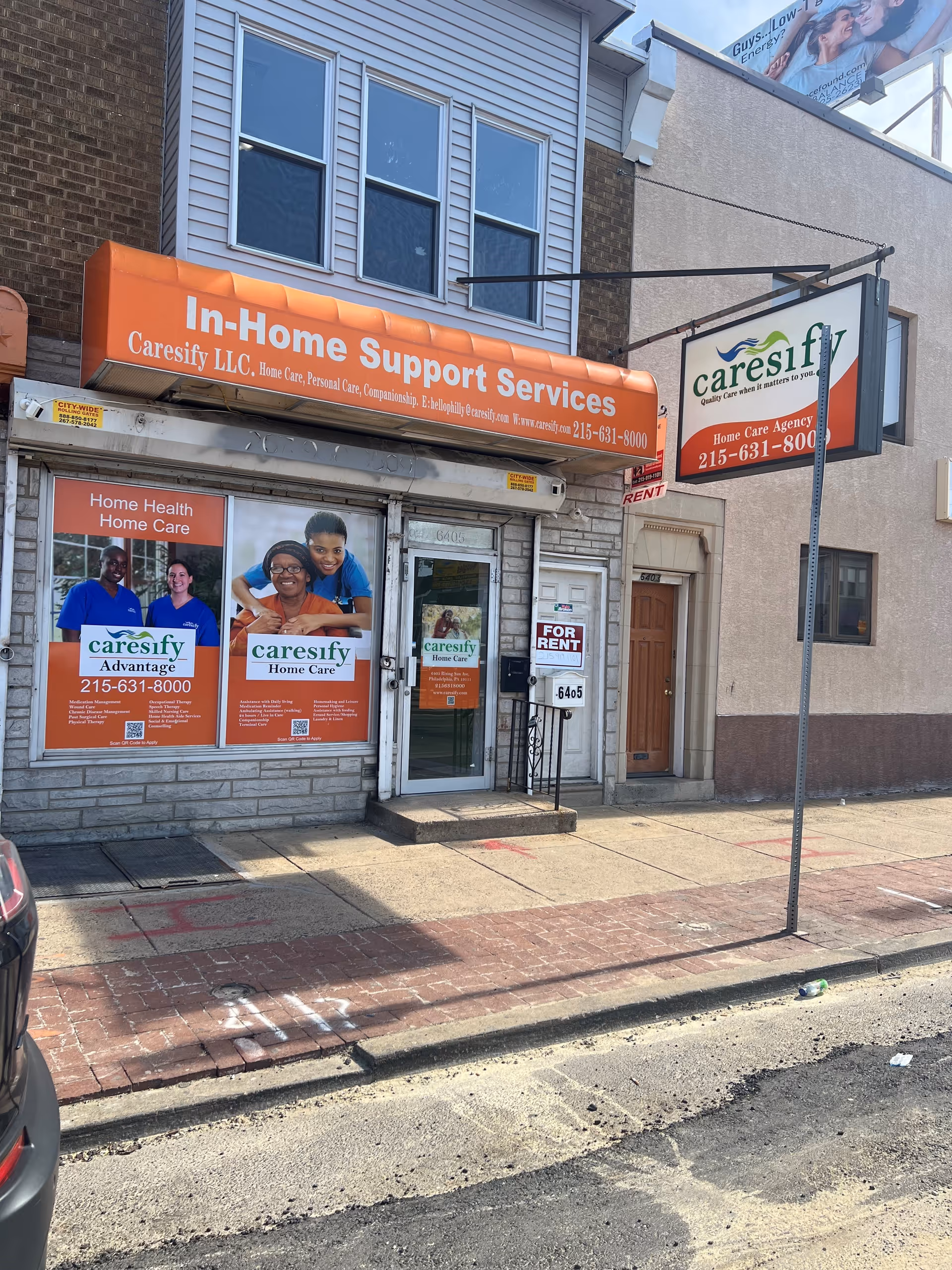 Storefront of In-Home Support Services with an orange awning and promotional posters.