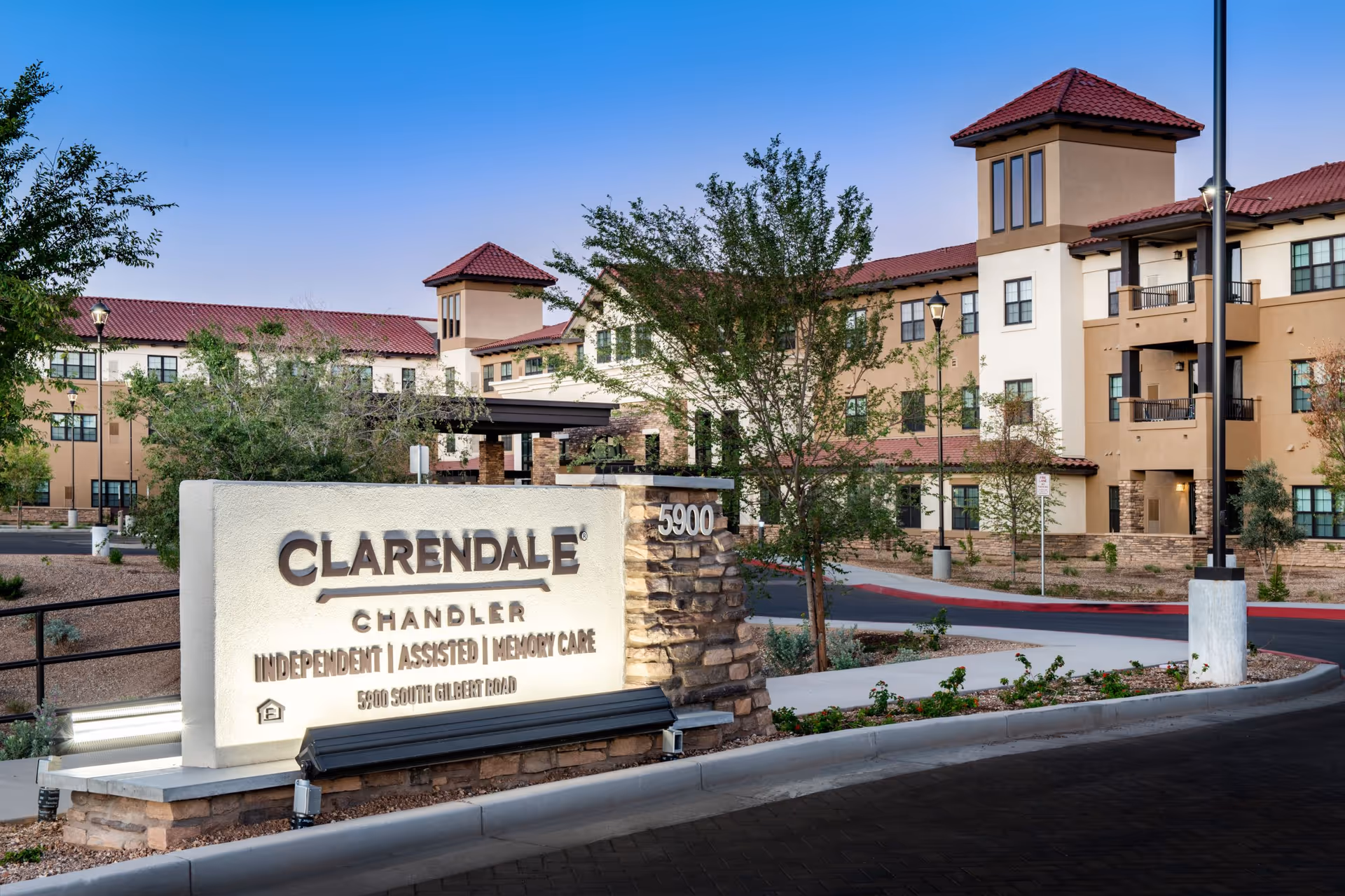 Exterior view of Clarendale of Chandler with a stone sign and multi-story building.
