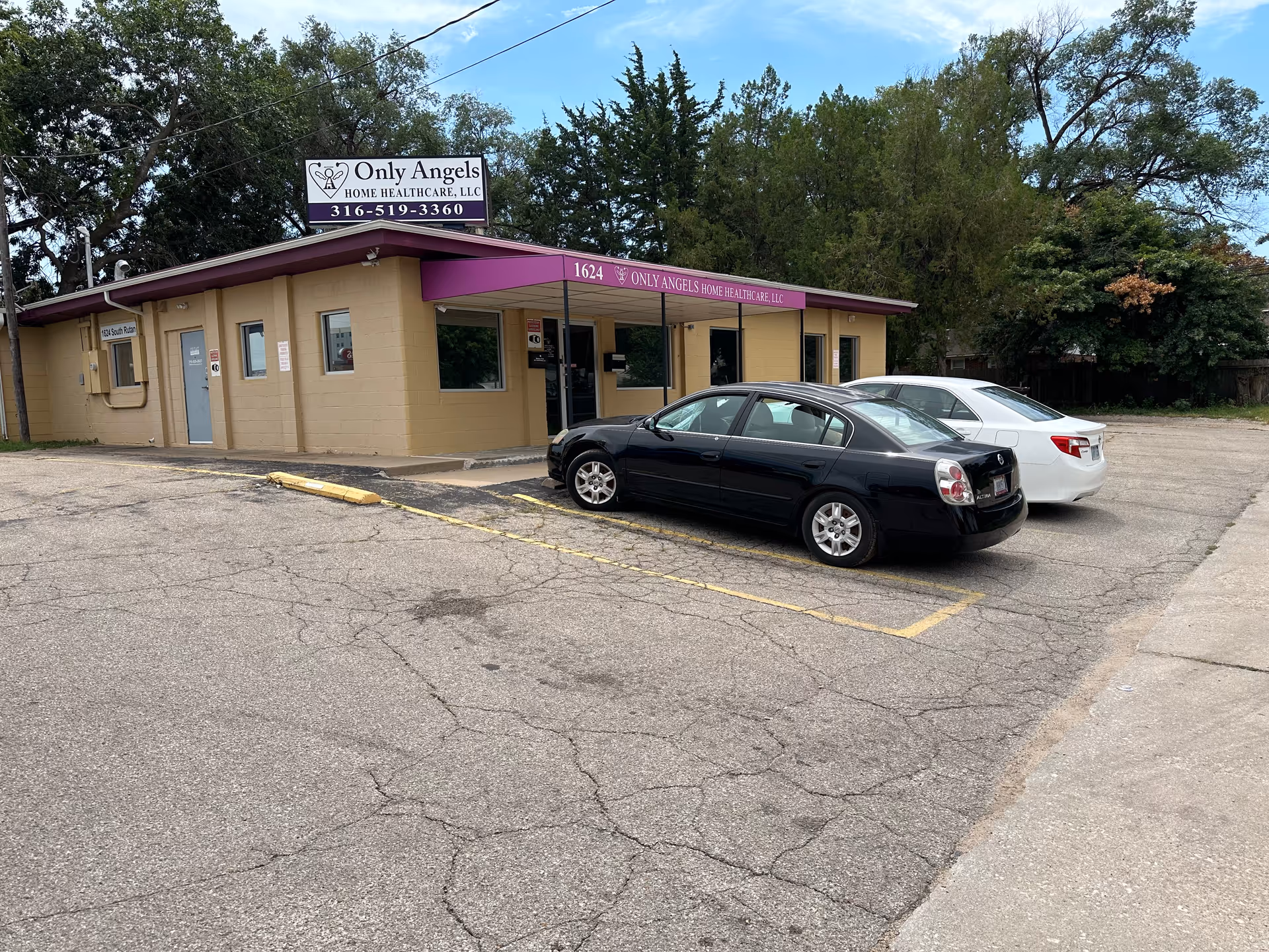 Exterior view of Only Angels Home Health Care building with purple awning and parked cars.