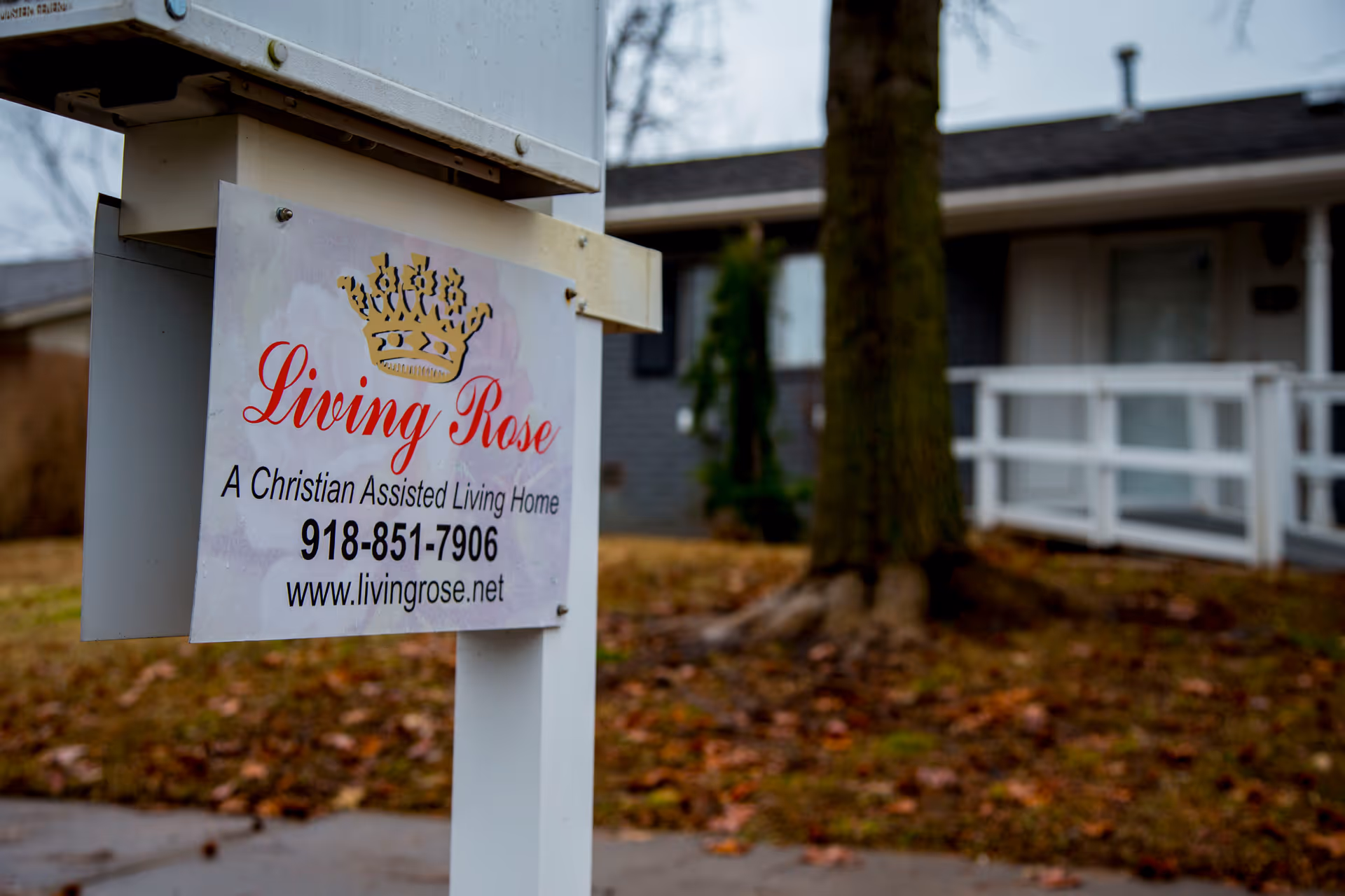 Sign for Living Rose Christian Assisted Living Home in front yard near house