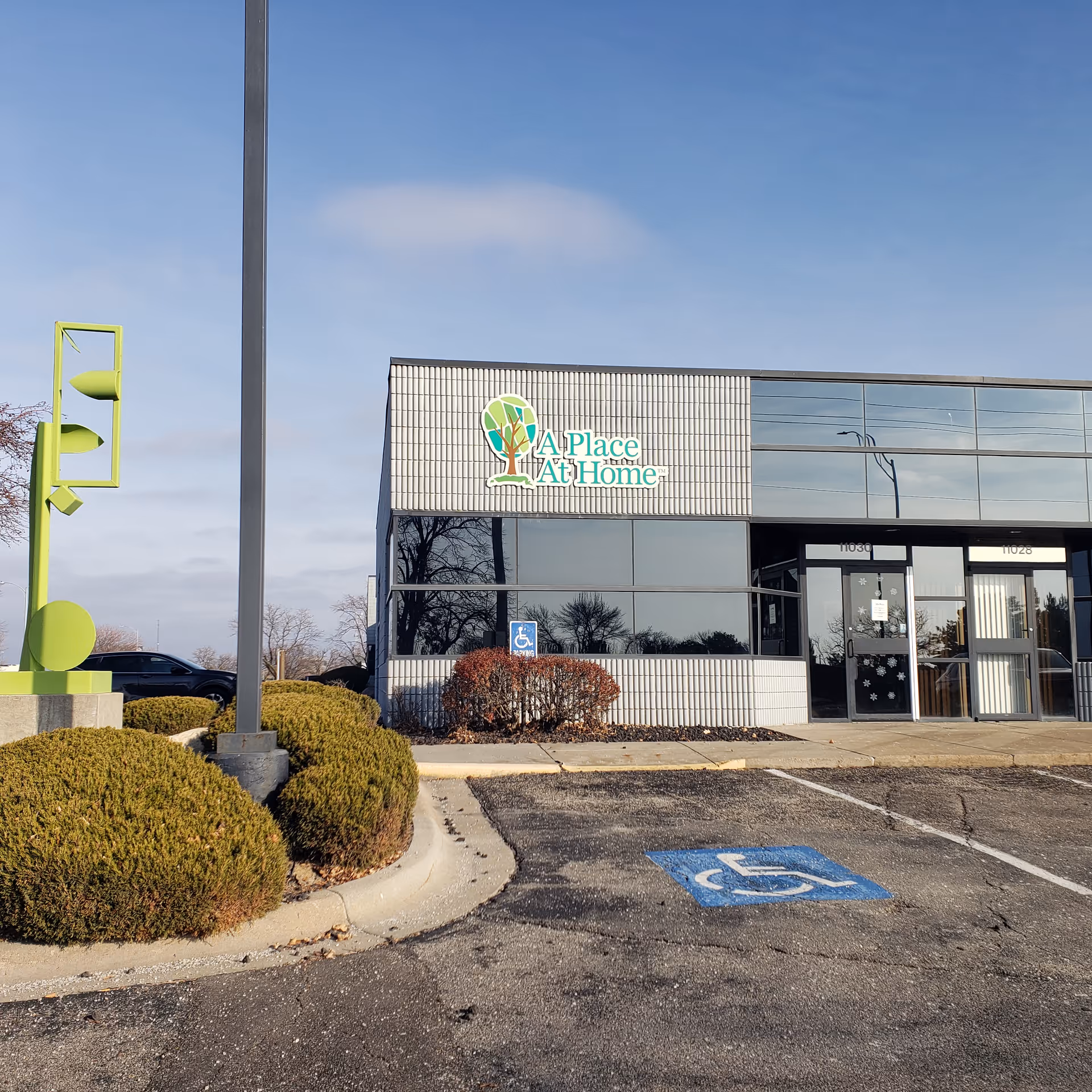 Front exterior of A Place At Home Omaha facility with handicap parking and entrance.
