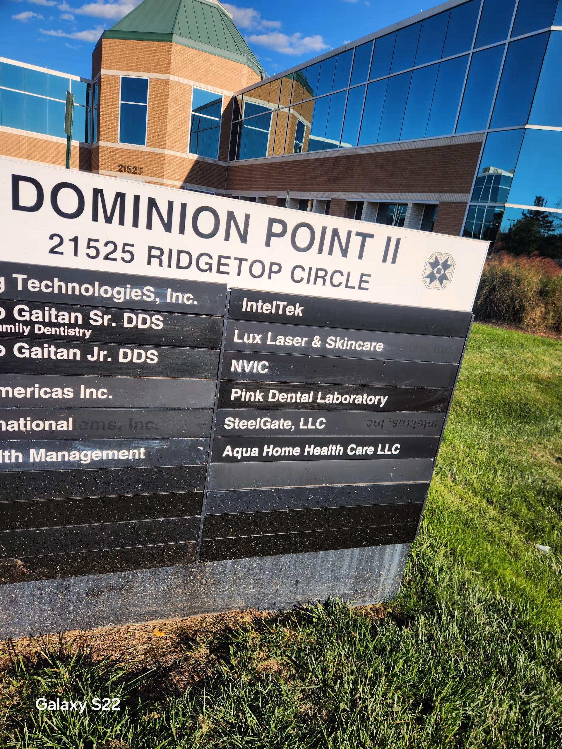 Exterior building with a multi-tenant signboard featuring Aqua Home Health Care LLC.