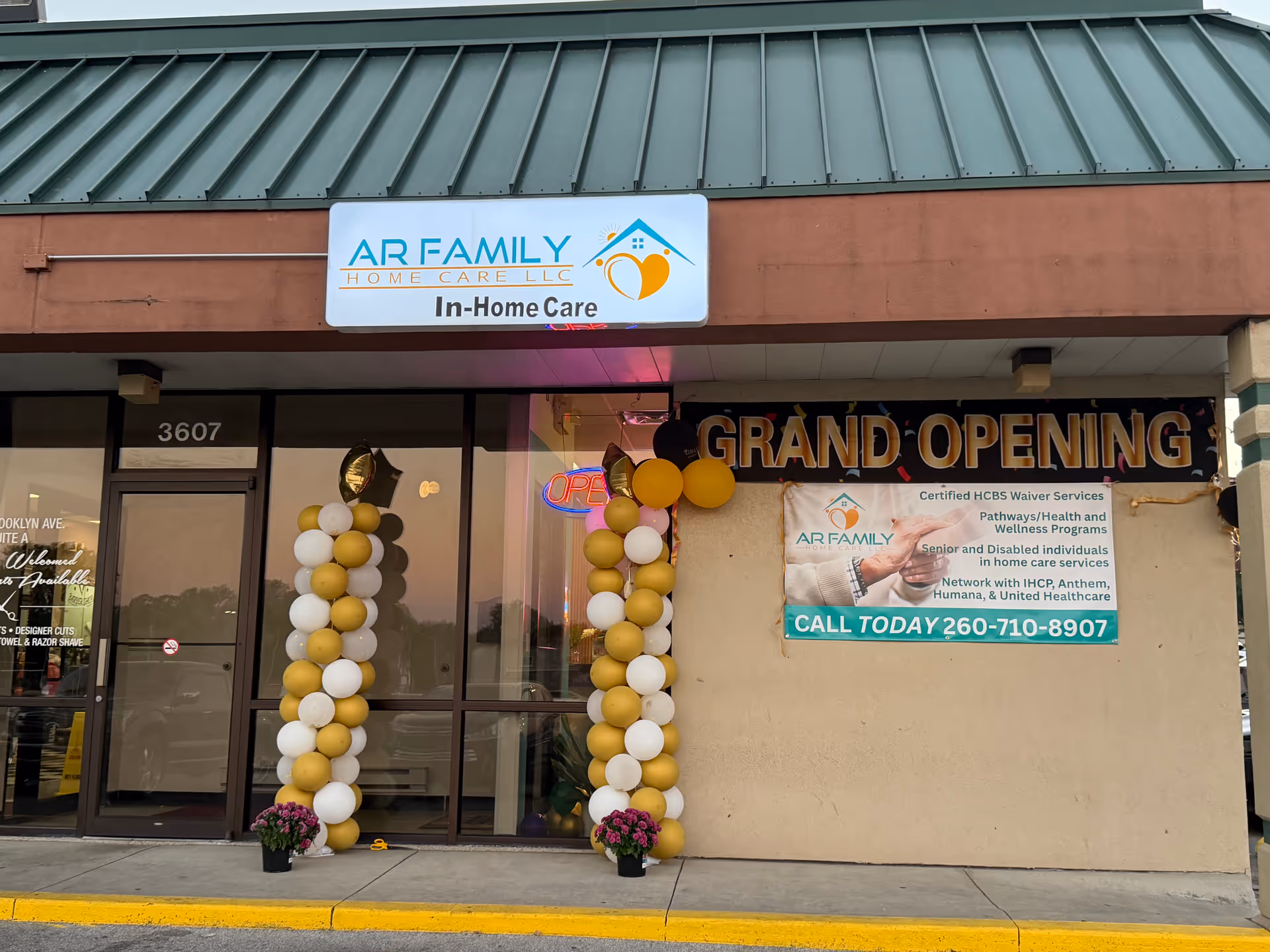 Storefront with AR Family Home Care LLC sign and grand opening balloons.