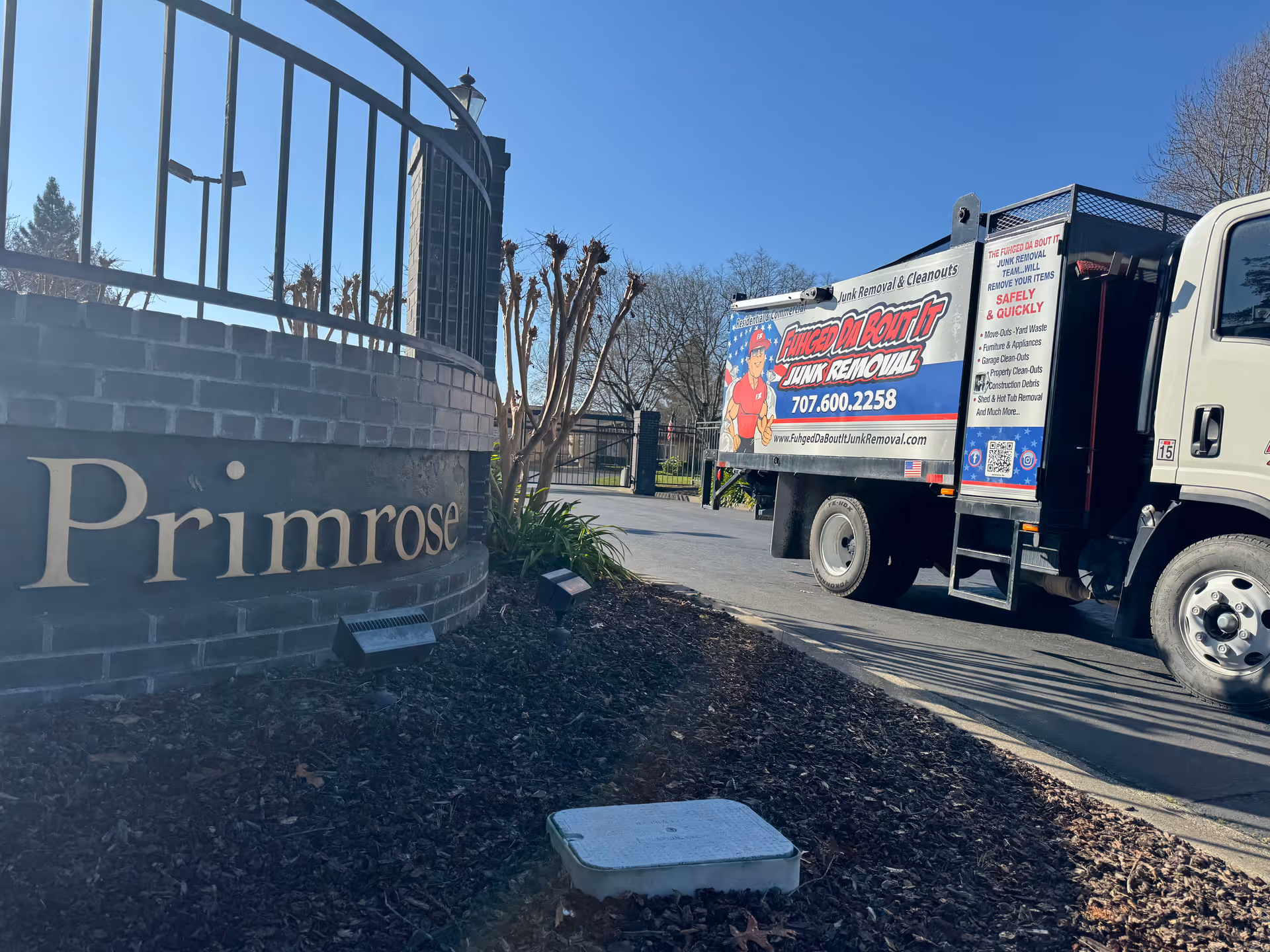 Exterior view shows Primrose entrance with a junk removal truck parked nearby.
