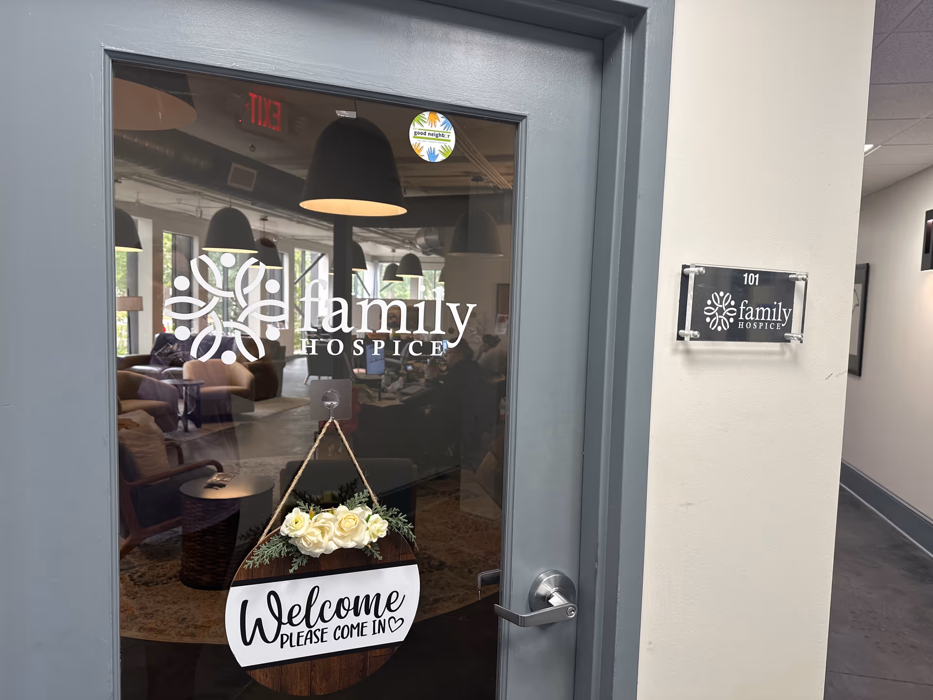 Glass door shows a lobby with seating and a Welcome sign at Family Hospice Athens.