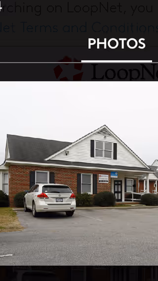 Exterior view of Brentwood Home Care Agency facility with a parked white car.
