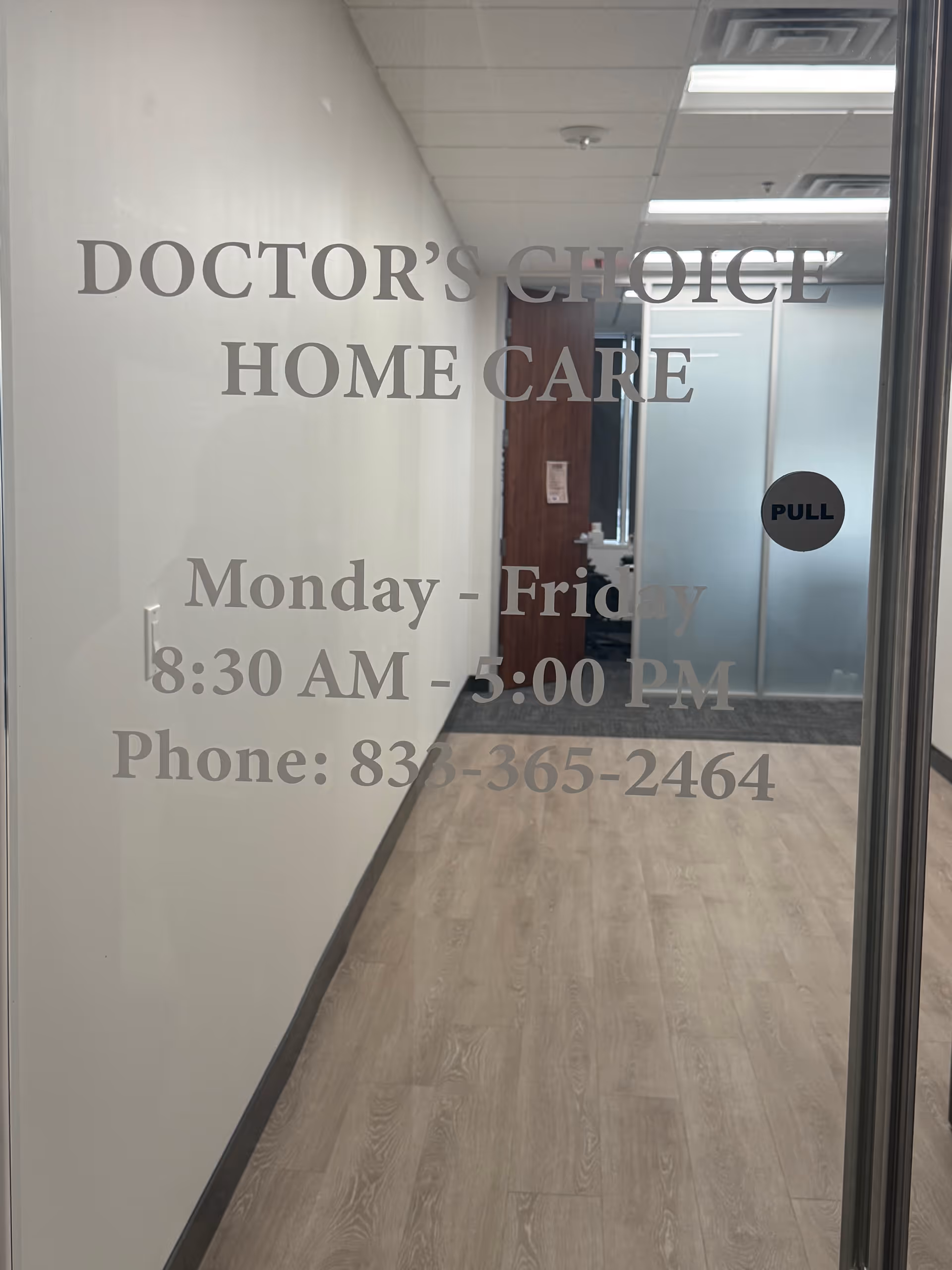 Interior hallway with glass door signage reading Doctor's Choice Home Care