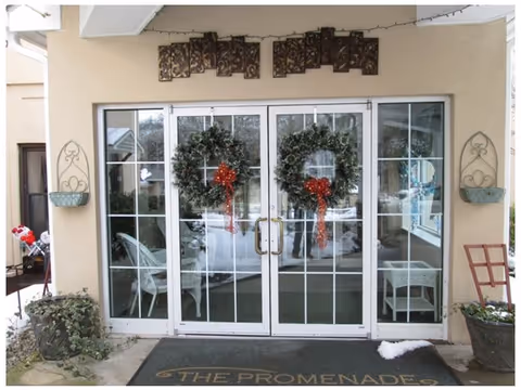 Glass double doors with wreaths greet visitors at the Promenade entrance.