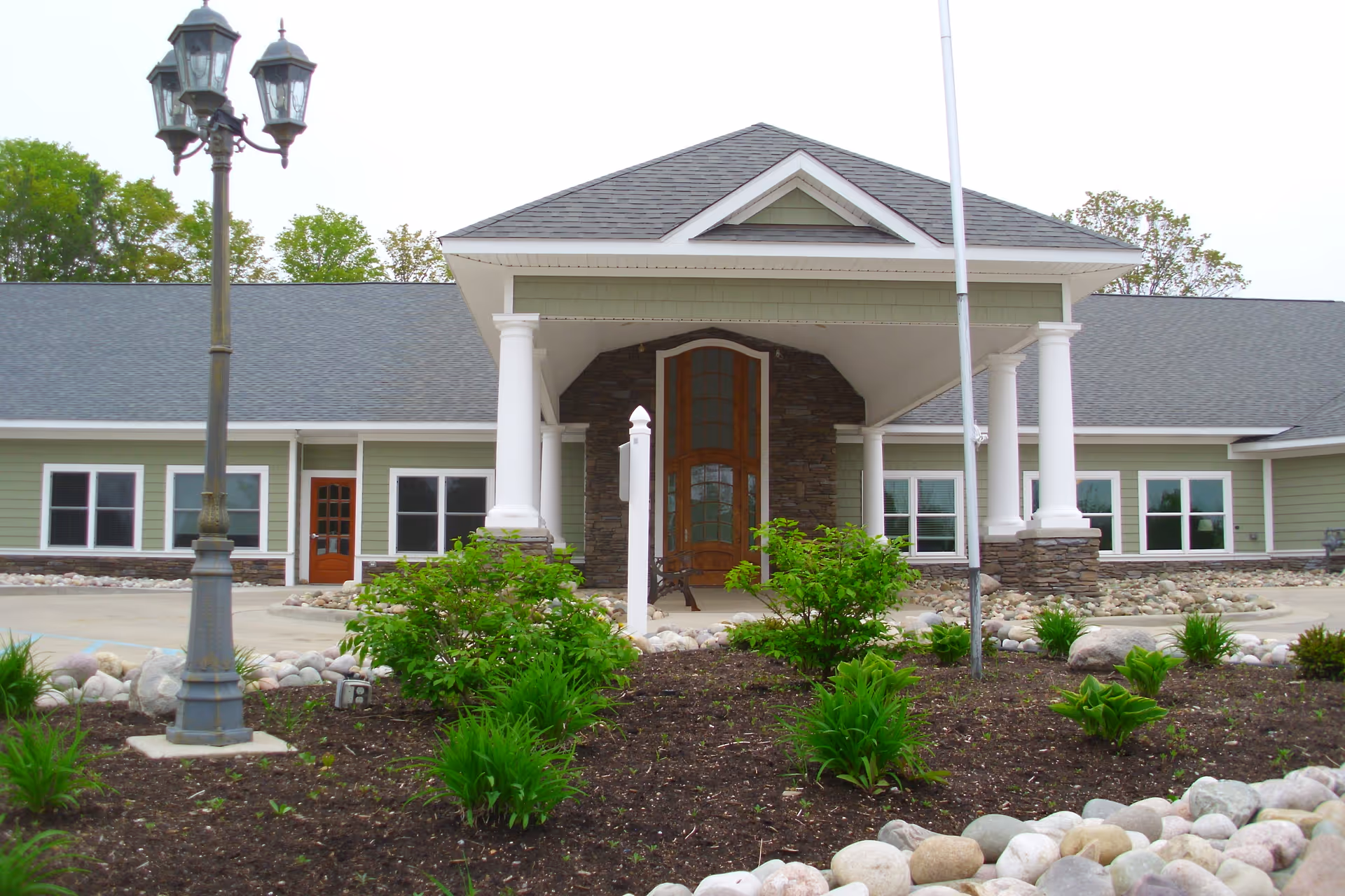 Front view of Mallard Cove Assisted Living building with stone entrance and columns.