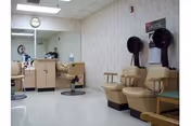 Interior of a senior living facility featuring a salon area with chairs, mirrors, and equipment.
