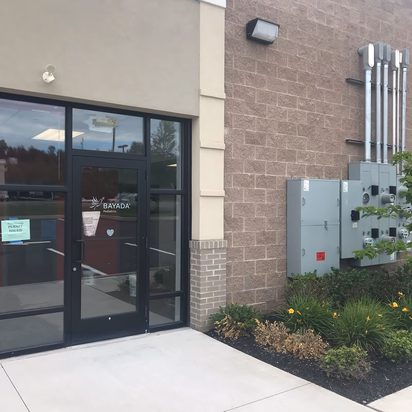 Exterior BAYADA Adult Assistive Care entrance with glass doors.