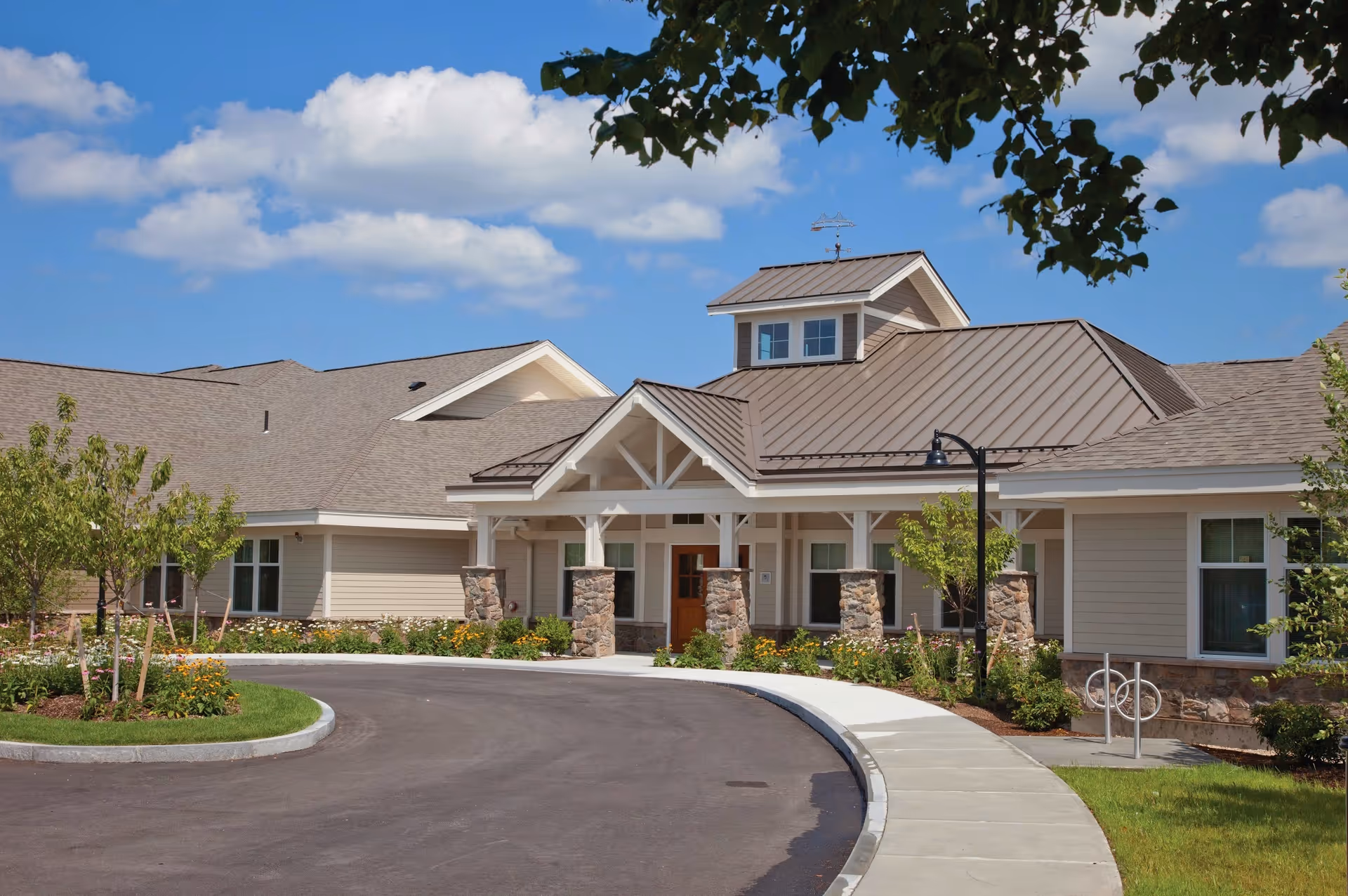 Front exterior of Bridges by Epoch at Lexington, showing the entrance, driveway, and landscaped surroundings.