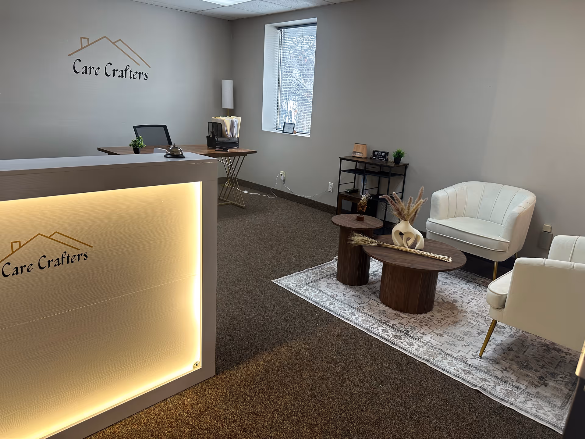 Reception area with Care Crafters logo, seating, and a front desk.