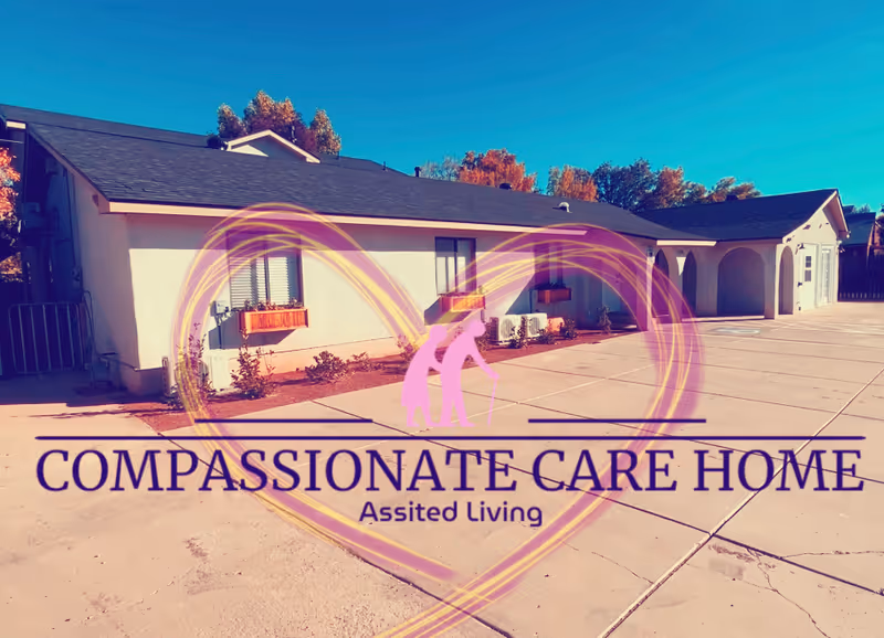 Single-story assisted living building with a paved front and a Compassionate Care Home logo.
