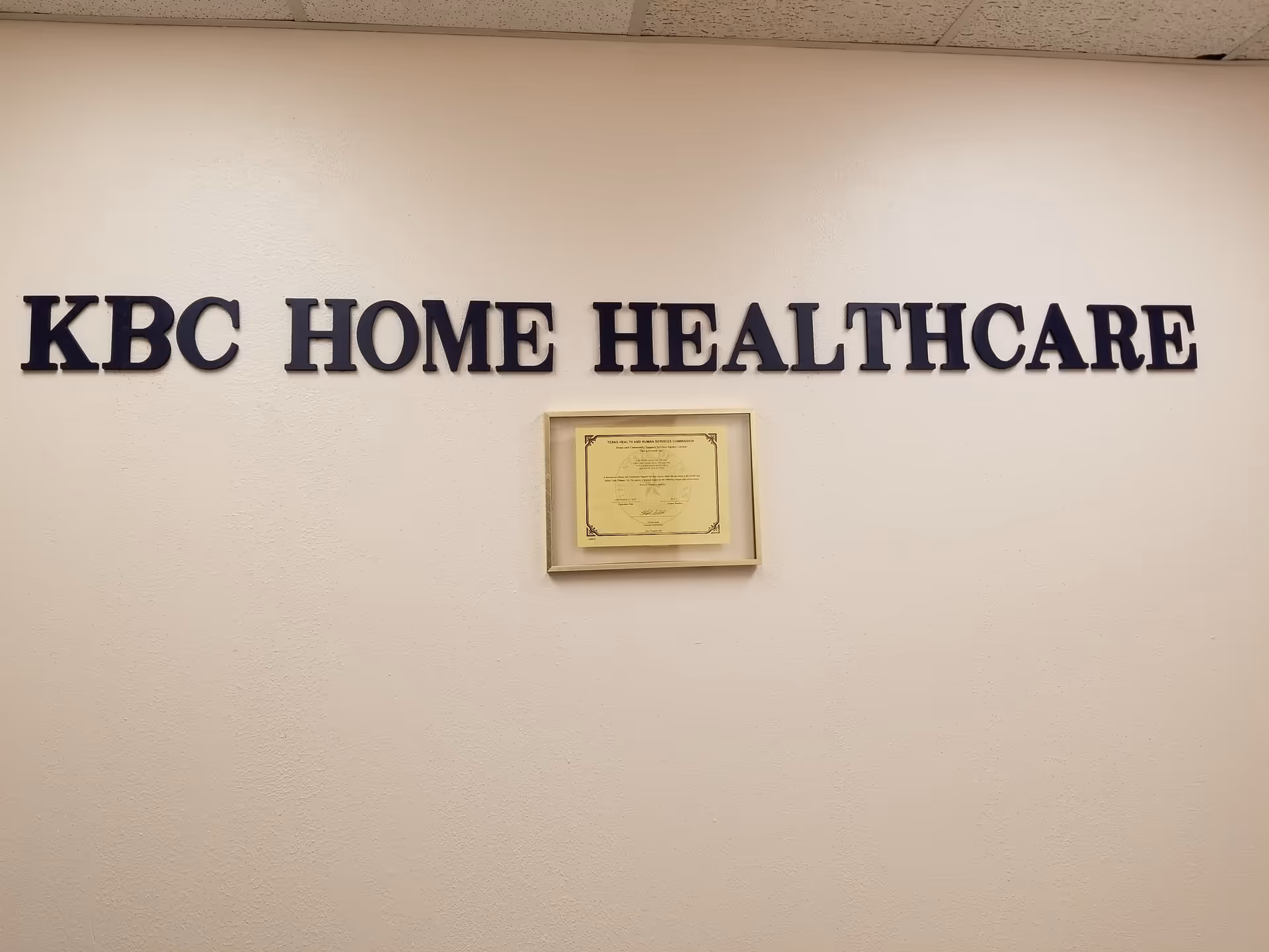 Interior wall displaying KBC HOME HEALTHCARE sign and a framed certificate.