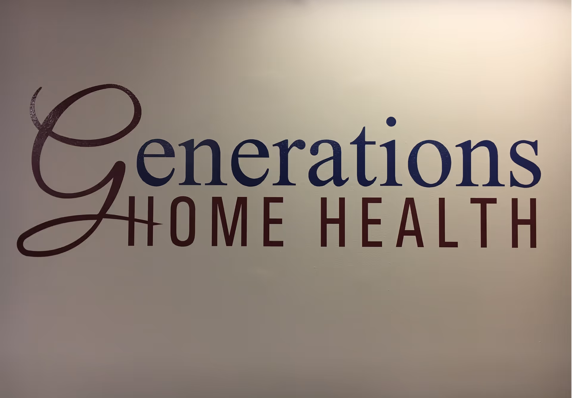 Interior wall with Generations Home Health logo in blue and maroon lettering.
