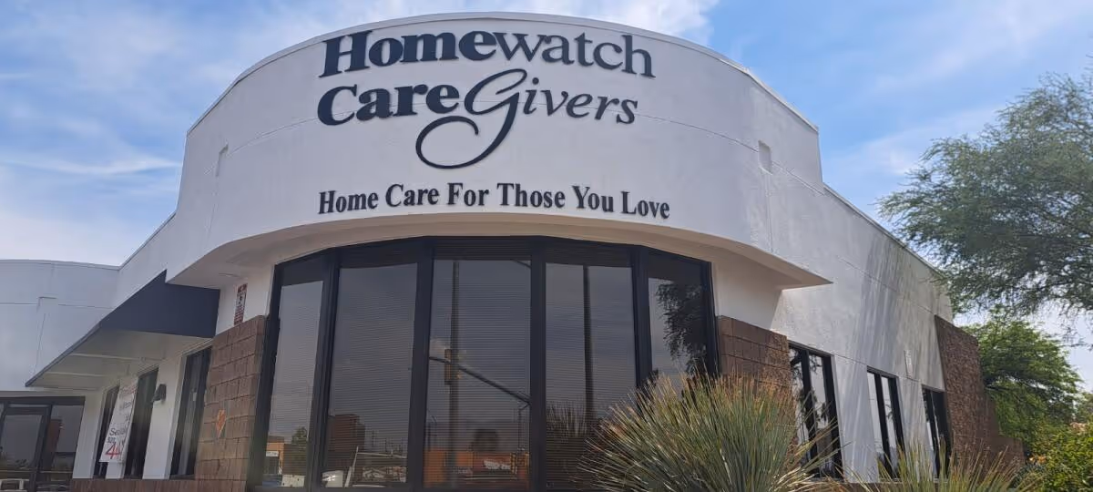 Exterior facade of Homewatch CareGivers building with large glass windows and sign.