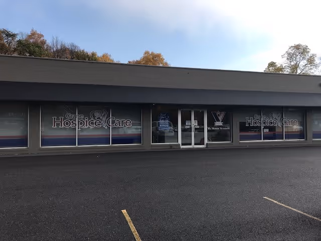 Front view of Grane Hospice Care building with glass doors and parking lot.