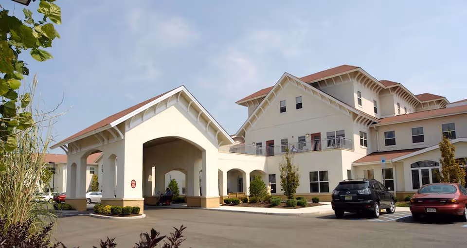 Exterior view of United Methodist Communities at The Shores with entrance canopy and parked cars