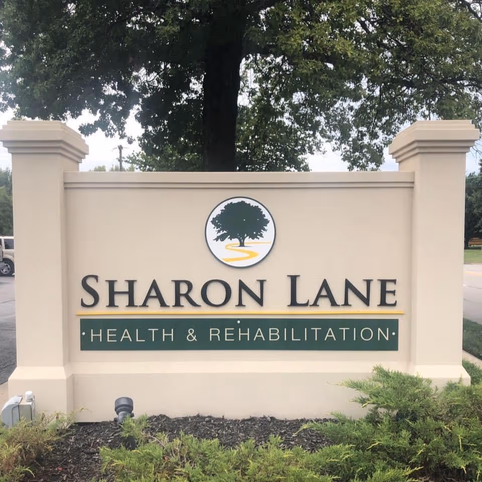 Sharon Lane Health and Rehabilitation sign on a beige front monument.