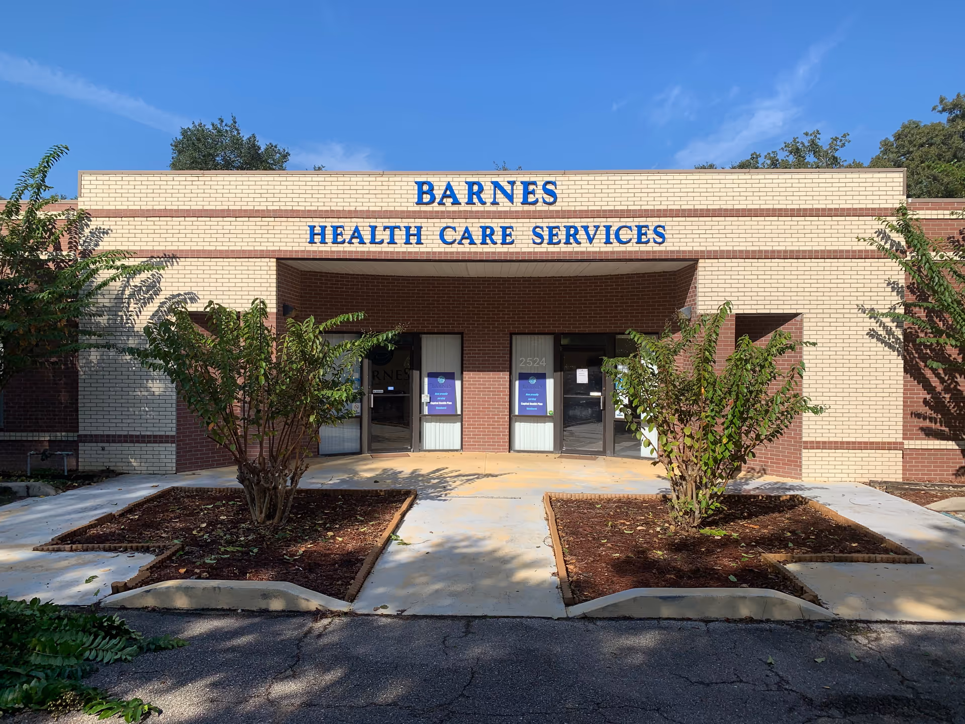 Front view of Barnes Health Care Services building with entrance and landscaping.