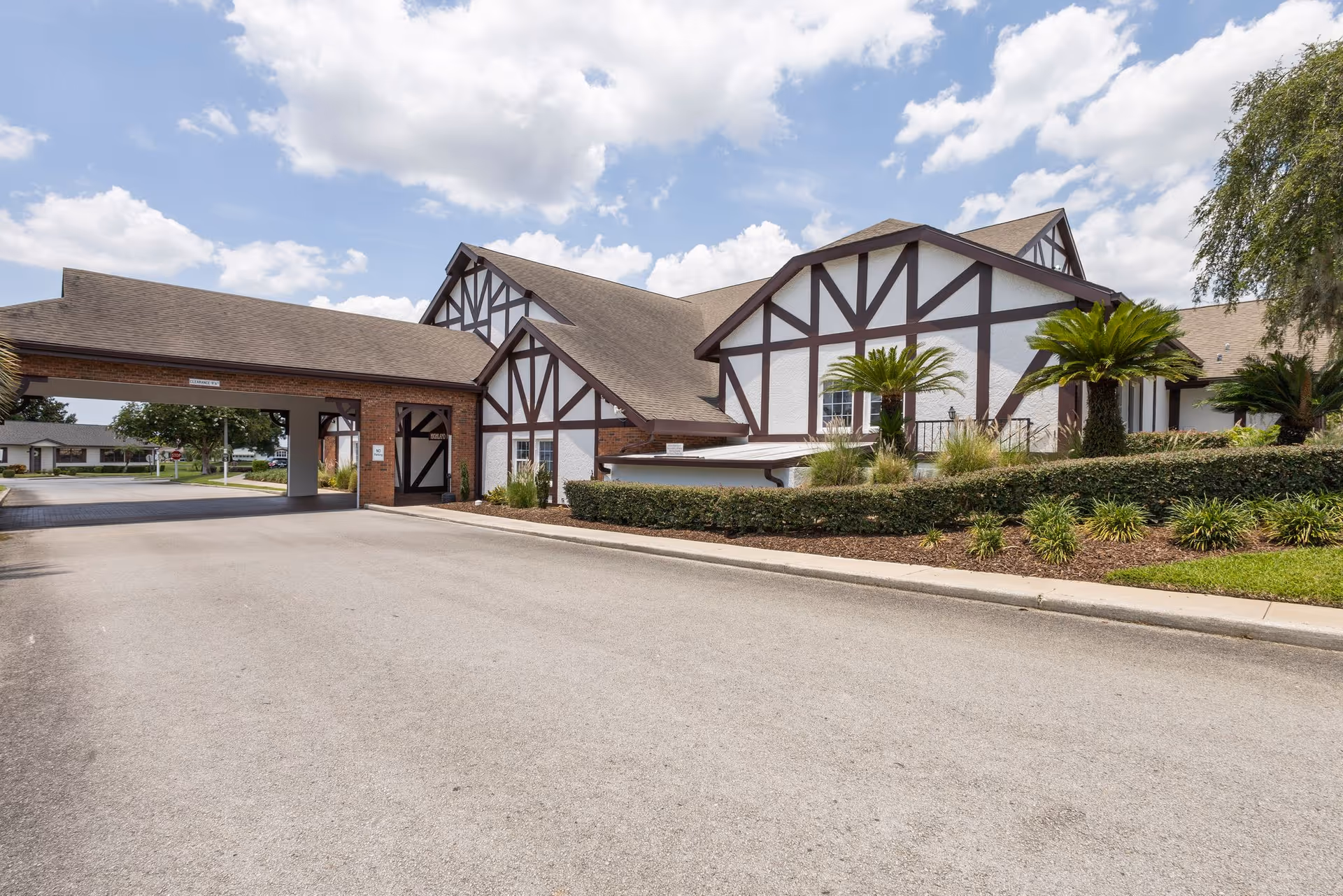 Exterior view of Highland Fairways Lakeland showing tudor-style facade and landscaping.