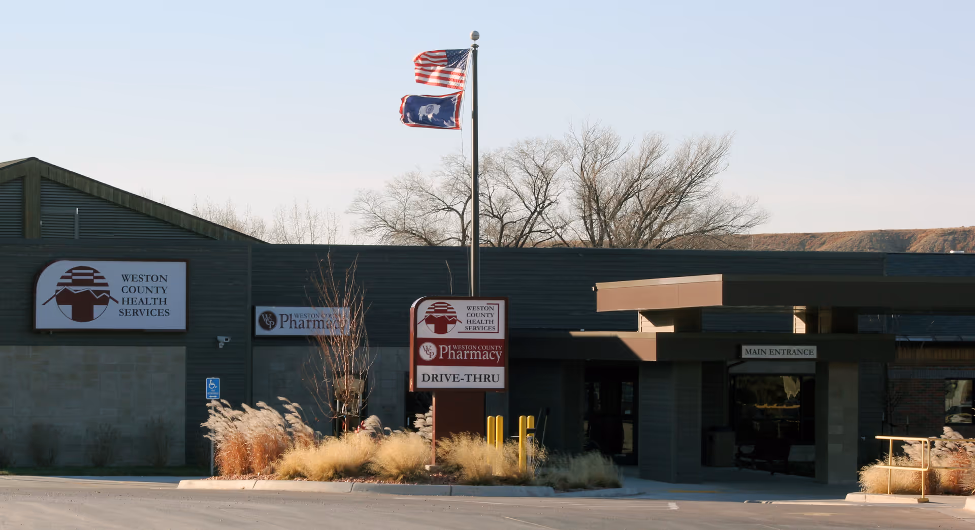 Weston County Health Services building front with flags, signage, and main entrance