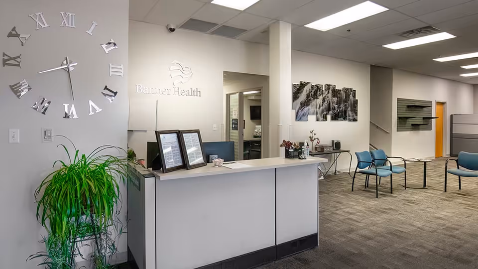 Reception desk in a modern Banner Health lobby with seating and wall art