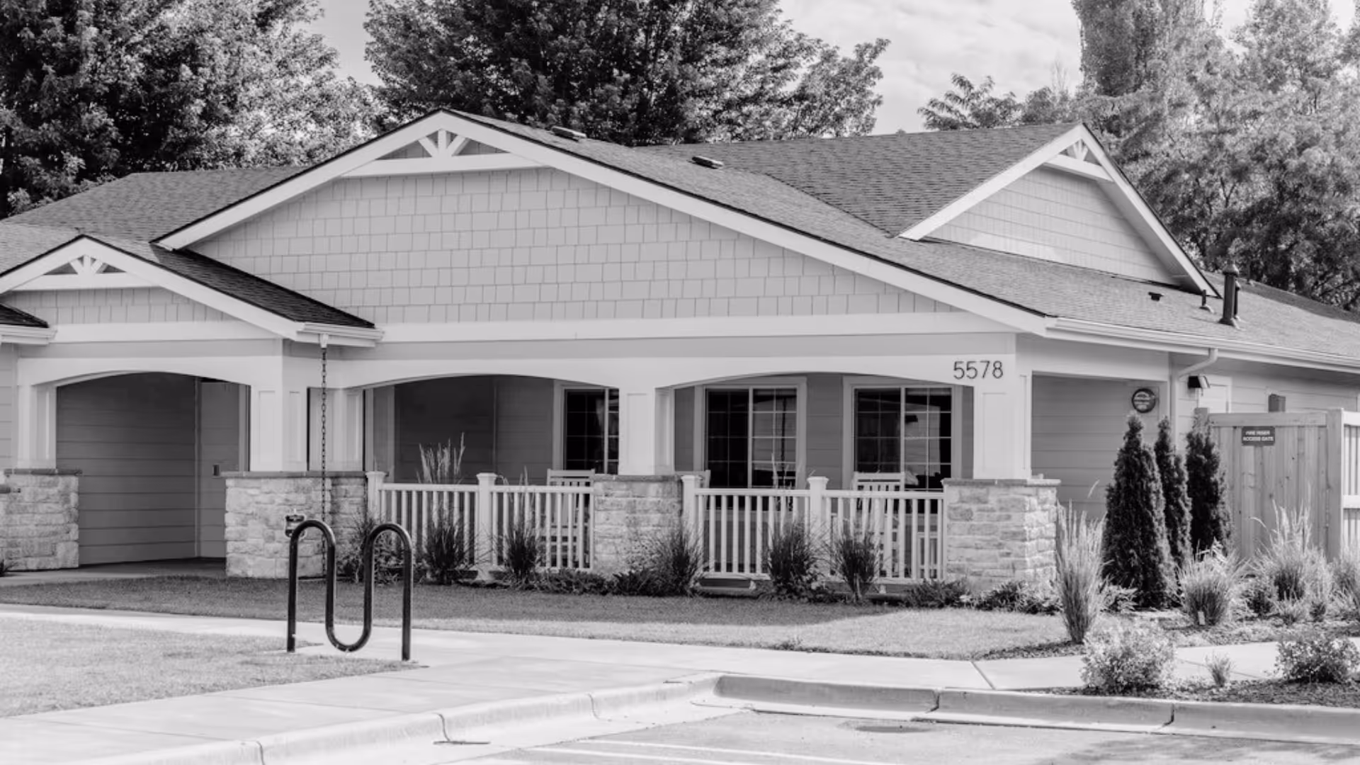 Single-story senior living facility with a covered front porch and manicured landscaping.