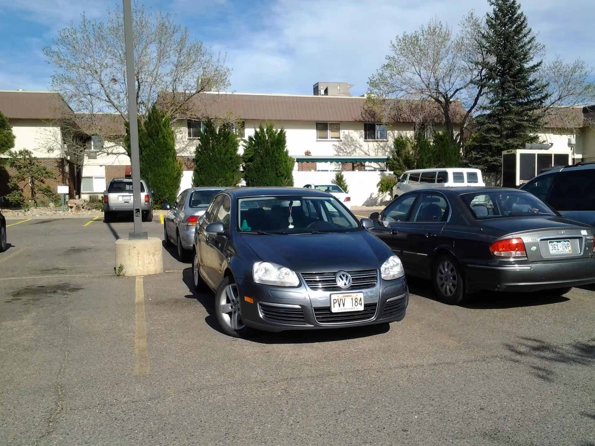 Parking lot in front of Berkley Manor Care Center with several parked cars.
