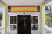 Entrance to The Care Center of Honolulu with glass doors and a sign.