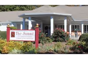 Exterior view of Summit of Lawrenceburg entrance with sign and landscaped garden.