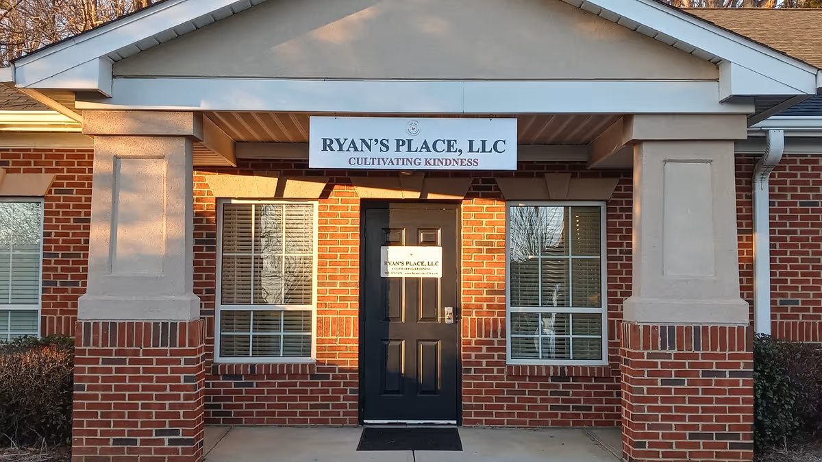 Brick facility entrance with black door and sign reading Ryan's Place, LLC Cultivating Kindness.