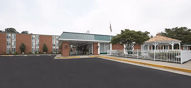 Exterior view of Charlottesville Health & Rehabilitation Center with driveway and gazebo.
