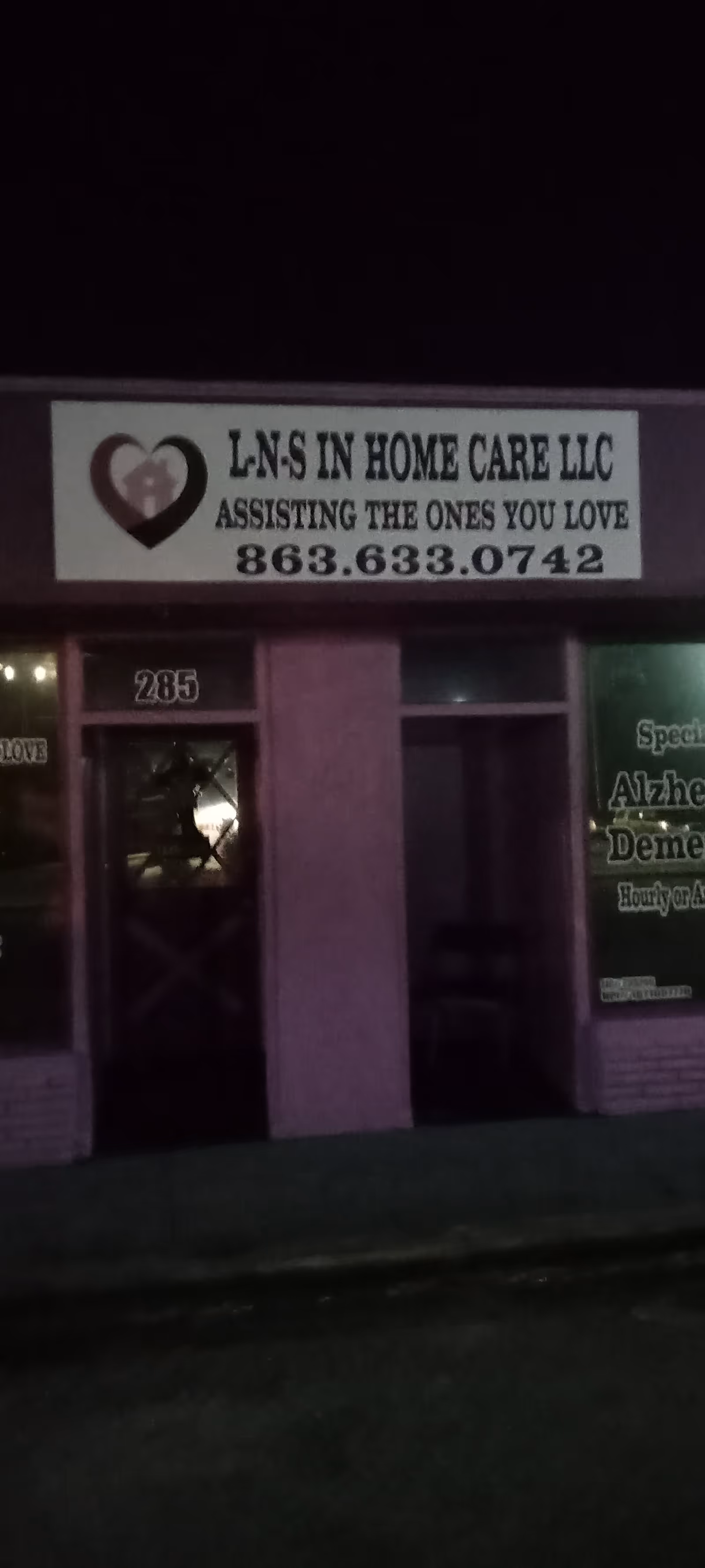 Exterior storefront at night with L-N-S In Home Care LLC sign above entrance.