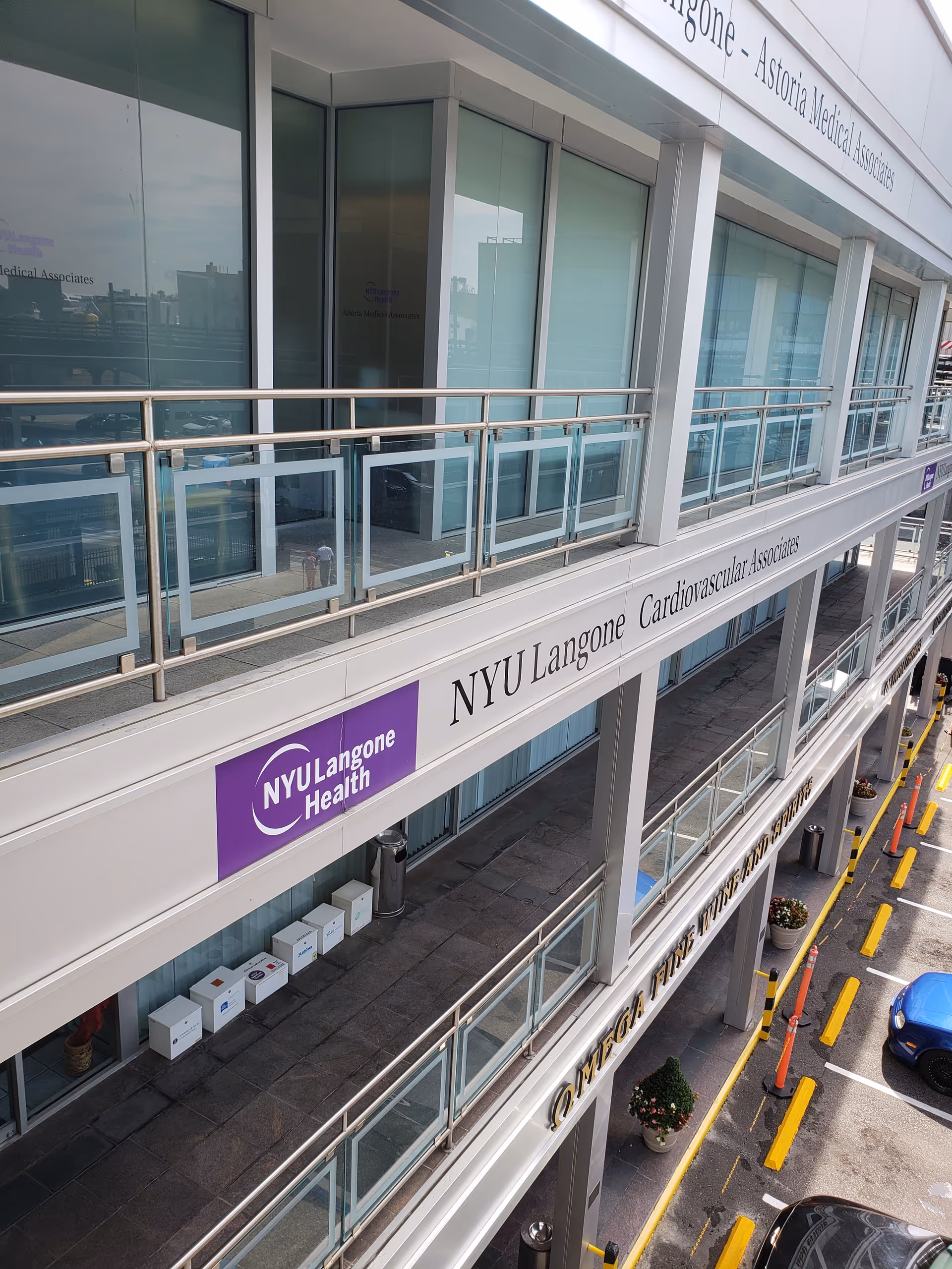 Exterior view of NYU Langone Astoria Medical Associates building with glass windows and signage.