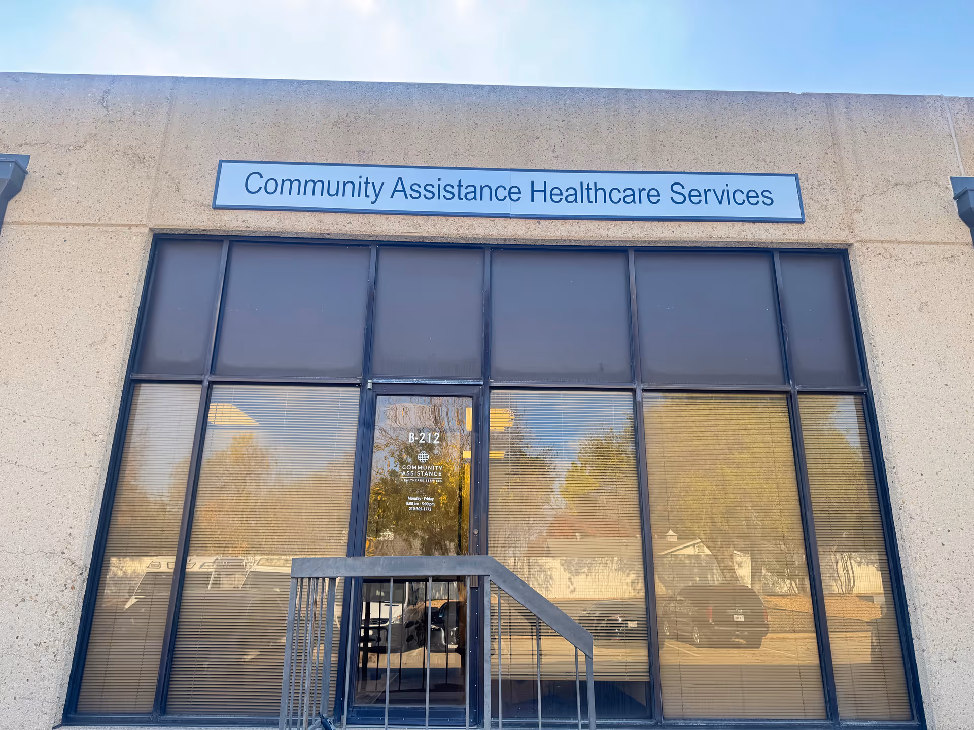 Exterior of Community Assistance Healthcare Services building with glass entry and sign.