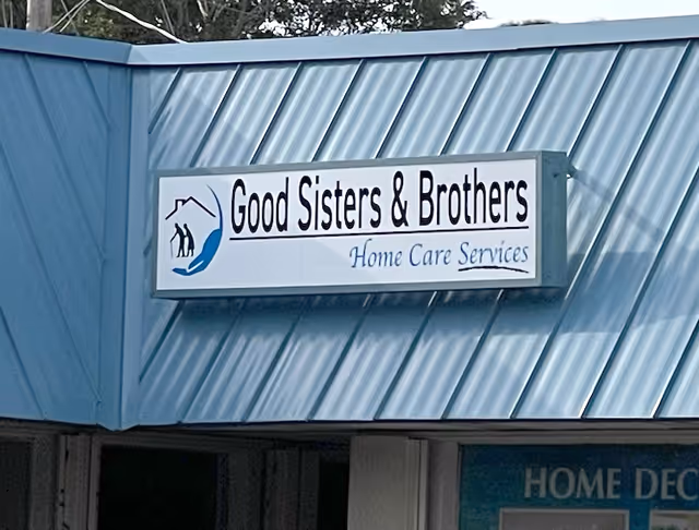 Blue building exterior with a sign reading Good Sisters & Brothers Home Care Services.