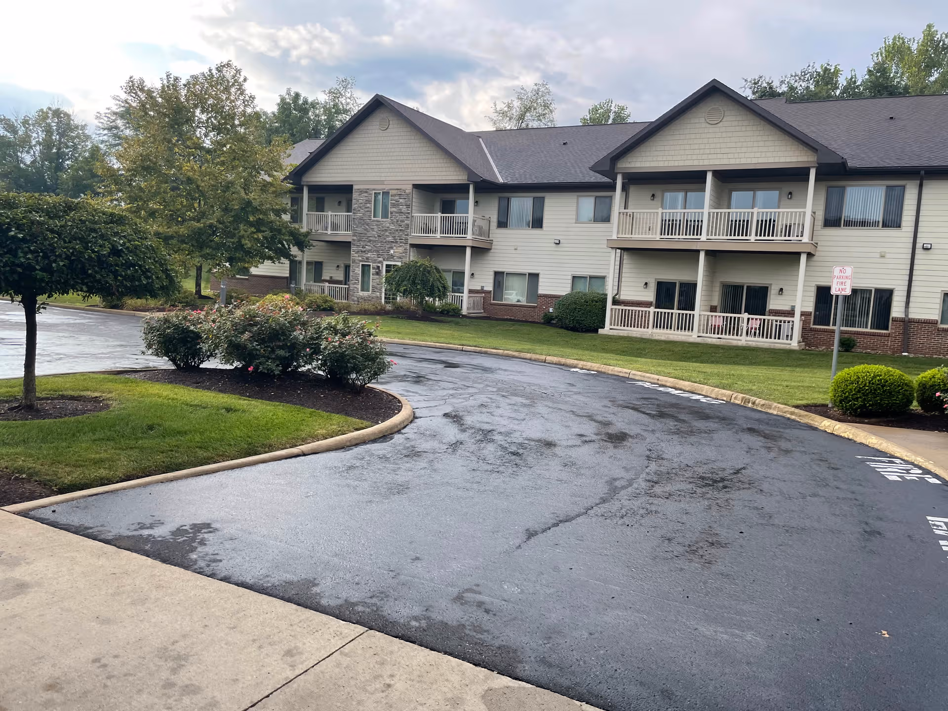 Exterior view of Primrose Retirement Community of Lancaster showing the front building, driveway, and landscaping.