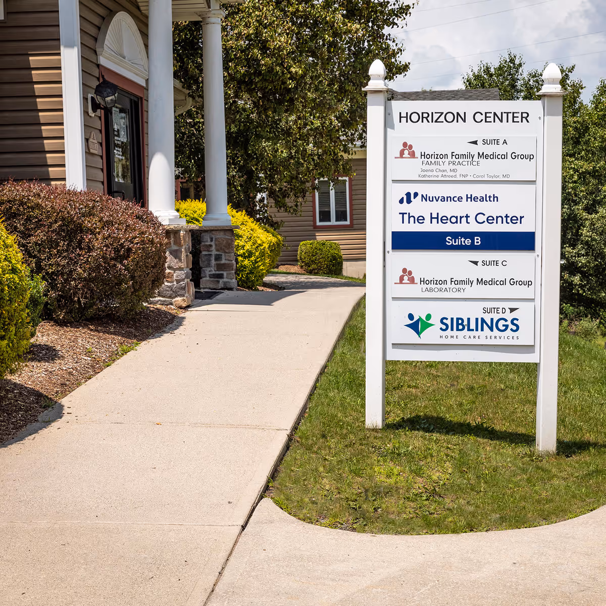 Exterior view of a building entrance with a sign for Horizon Center and The Heart Center.