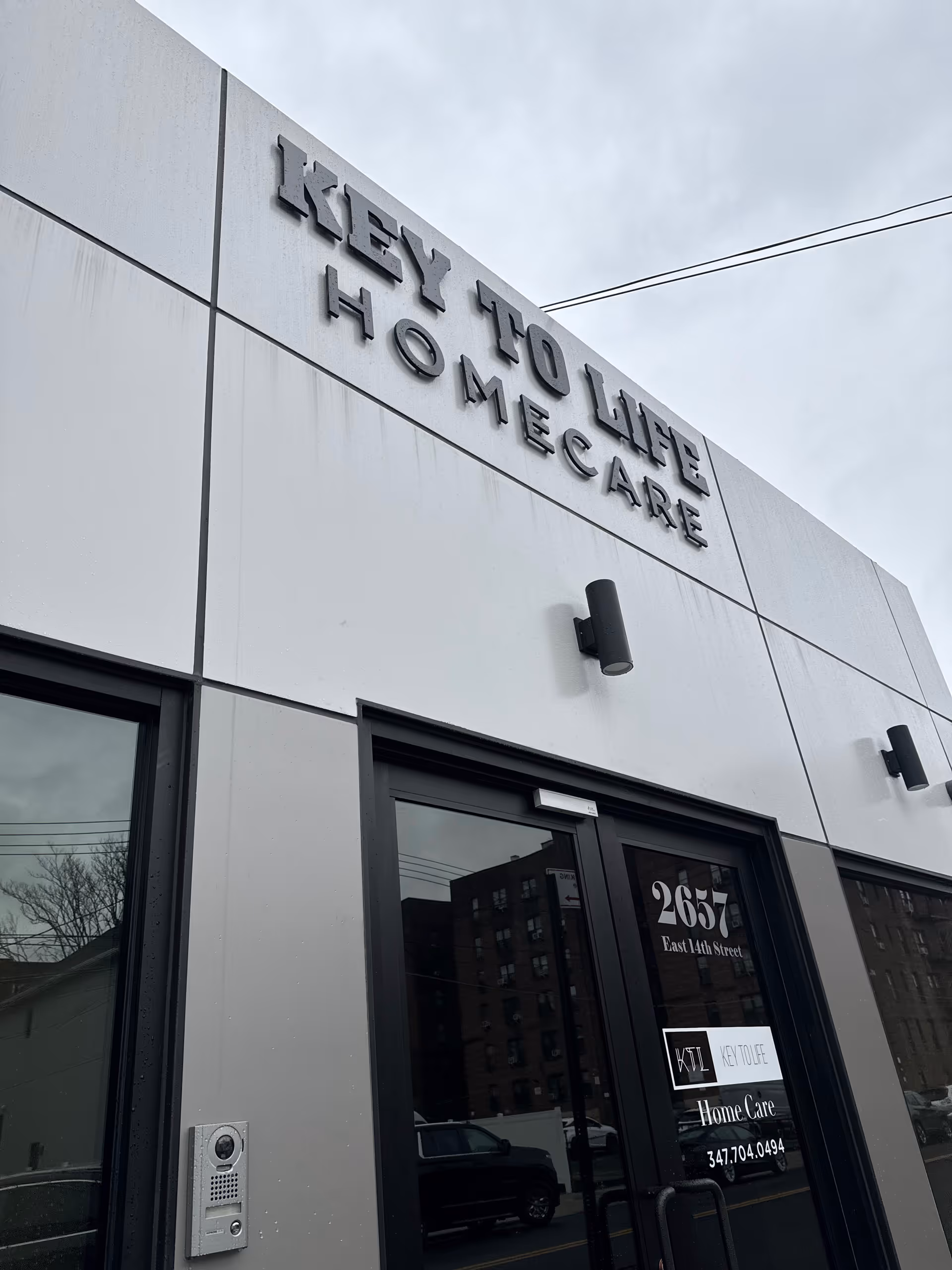 Exterior view of Key to Life Home Care facility front entrance and sign.