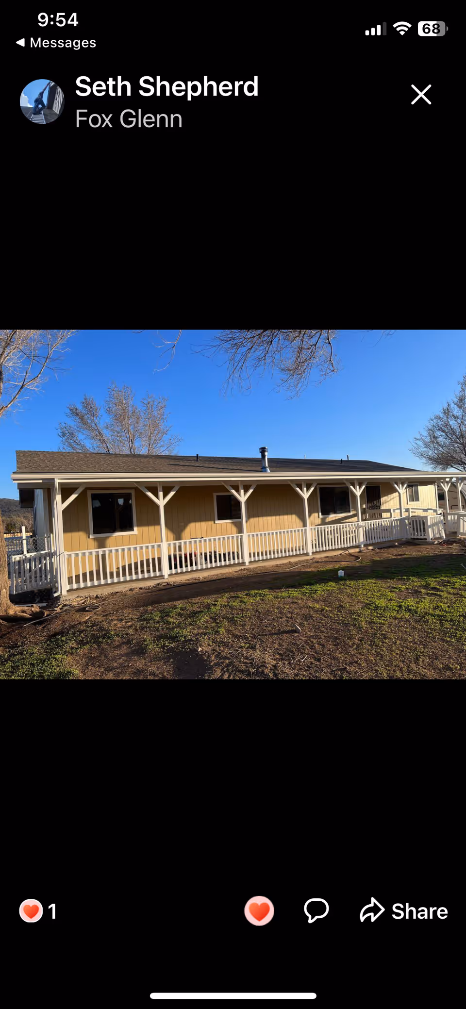 Single-story assisted living building with a front porch and white railing.